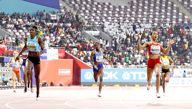 Salwa Eid Naser, of Bahrain, right, wins the gold medal in the women's 400 metre final ahead of Shaunae Miller-Uibo at the World Athletics Championships in Doha, Qatar. (AP Photo/Petr David Josek)