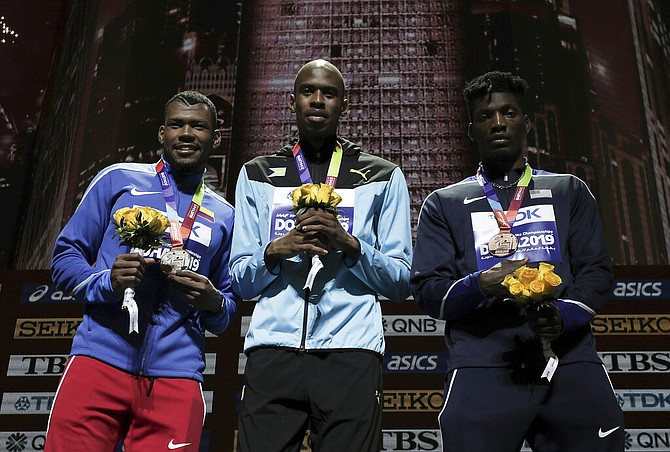 Steven Gardiner, gold, Anthony José Zambrano of Colombia, silver, and Fred Kerley, of the United States, bronze, during the medal ceremony for the men's 400m at the World Athletics Championships in Doha, Qatar, Saturday. (AP Photo/Nariman El-Mofty)