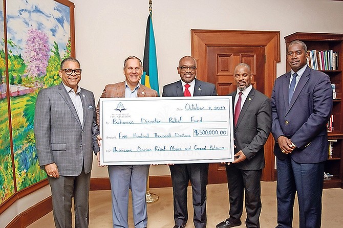 CHEQUE PRESENTATION: Prime Minister Dr Hubert Minnis (centre) accepts a donation from Baha Mar executives. Pictured, from left: Mr. Sandy Sands, Sr. Vice President, Baha Mar; Mr. Graeme Davis, President, Baha Mar; Prime Minister Minnis; Iram Lewis, Minister of State, Ministry of Disaster Preparedness, Management and Reconstruction; and Cpt. Stephen Russell, Director, National Emergency Management Agency (NEMA).    Photo/Yontalay Bowe
