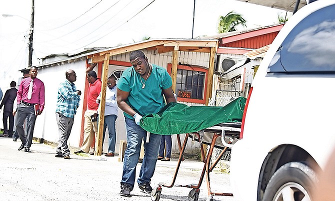 The body is removed from the scene on Tuesday. Photo: Shawn Hanna/Tribune staff