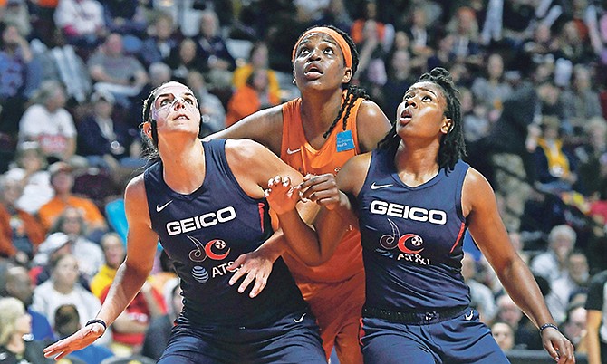 Connecticut Sun’s Jonquel Jones, centre, fights for position under the basket between Washington Mystics’ Elena Delle Donne, left, and Ariel Atkins, right, during the first half last night in Game 4 of the WNBA Finals in Uncasville, Connecticut.
(AP Photo/Jessica Hill)