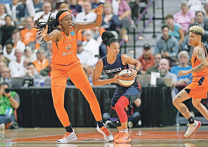 Washington Mystics’ Kristi Toliver, centre, tries to pass under pressure from Connecticut Sun’s Jonquel Jones, left, and Natisha Hiedeman, not in picture, during the first half in Game 4 of the WNBA Finals on Tuesday night.

(AP Photo/Jessica Hill)