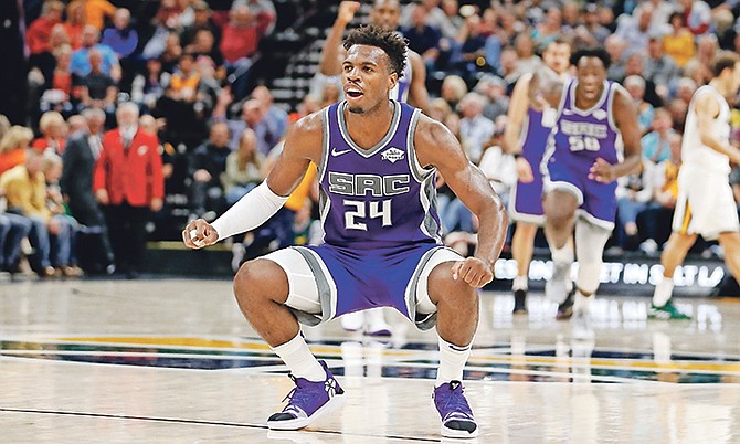 Sacramento Kings guard Buddy Hield (24) reacts after making a 3-pointer against the Utah Jazz at the end of the first half during a preseason game on October 14 in Salt Lake City.

(AP Photo/Rick Bowmer)