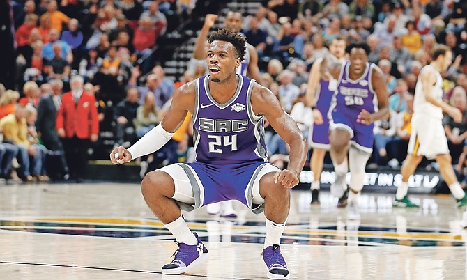 Sacramento Kings guard Buddy Hield (24) reacts after making a three-point basket against the Utah Jazz at the end of the first half during a preseason NBA basketball game Monday, Oct. 14, 2019, in Salt Lake City. (AP Photo/Rick Bowmer)