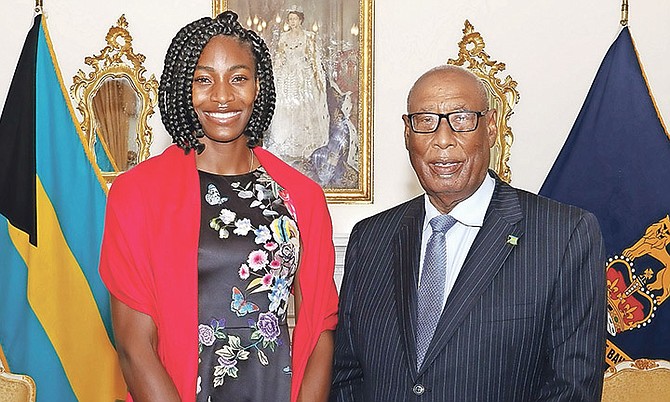 Shaunae Miller-Uibo was invested with her National Honour - the Order of Lignum Vitae - by Governor General CA Smith at Government House yesterday. Photo: Patrick Hanna/BIS