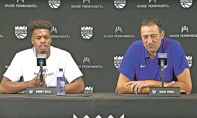 Sacramento’s Buddy Hield, left, can be seen during a press conference with Kings’ general manager Vlade Divac. Hield and Divac addressed the media for the first time since Hield signed his contract extension just hours before Monday’s deadline.