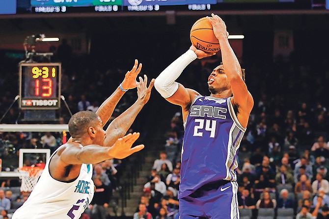 Sacramento Kings guard Buddy Hield, right, shoots over Charlotte Hornets forward Marvin Williams during the second half in Sacramento, California, on Wednesday night. The Hornets won 118-111.

(AP Photo/Rich Pedroncelli)