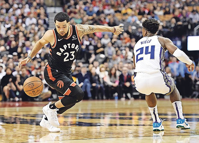 Raptors guard Fred VanVleet controls the ball as Kings guard Buddy Hield (24) defends.

(Nathan Denette/The Canadian Press via AP)