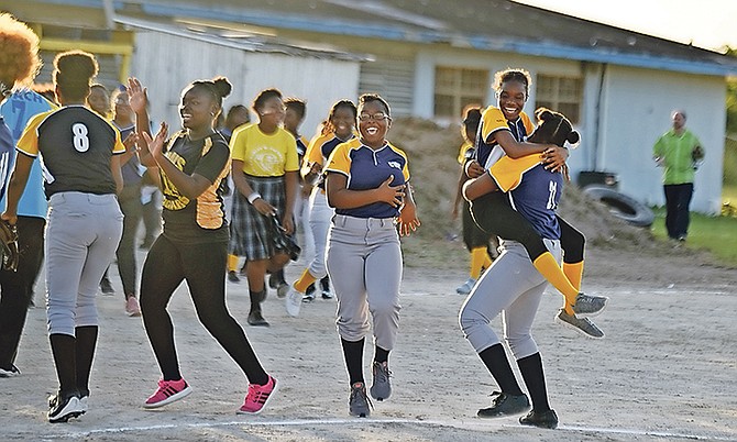 Charles W Saunders Cougars junior girls celebrate yesterday after defeating St Augustine’s College Big Red Machine 11-8 in game 1 of their Bahamas Association of Independent Secondary Schools best-of-three softball championship series at home. The Cougars are still undefeated.               
Photos: Shawn Hanna/Tribune Staff