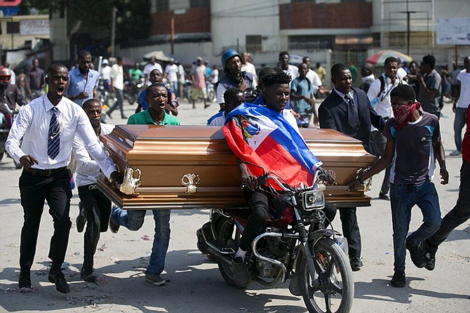 Family and friends transport the coffin that contain the remains of a protester who was recently killed, in Port-au-Prince, Haiti, Tuesday. (AP)