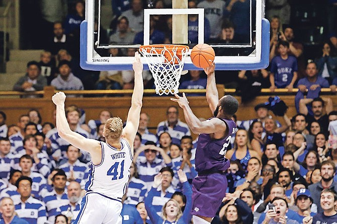 Stephen F Austin forward Nathan Bain, right, drives for a game-winning basket over Duke forward Jack White during overtime in an NCAA college basketball game on Tuesday. Stephen F Austin won 85-83. Photo: Gerry Broome/AP