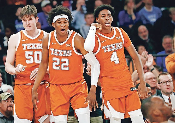 Texas centre Will Baker (50), forward Kai Jones, and guard Donovan Williams react on the sideline after guard Matt Coleman III drew a foul during the second half against California in the 2K Empire Classic on November 22 in New York.

(AP Photo/Kathy Willens)