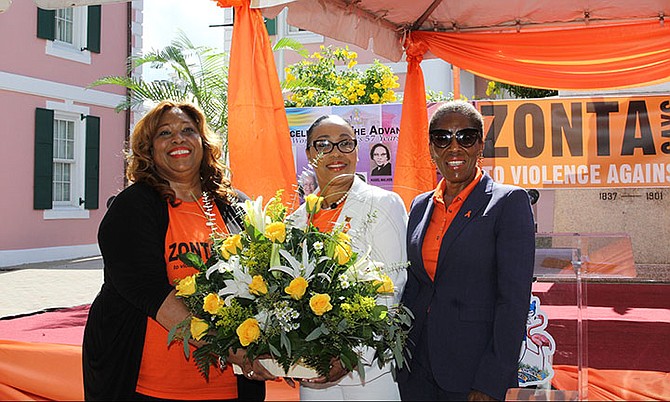 Kayla Darville (centre) presents a bouquet to the Prime Minister’s wife, Patricia Minnis, along with National Advocacy Campaign Coordinator, Marisa Mason Smith.