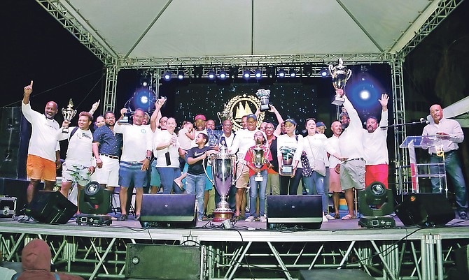 Minister of Agriculture and Marine Resources Michael Pintard presents the trophy to Running Tide, winners of Class A at the Best-of-the-Best Regatta in Montagu Bay over the weekend.
                                                                                                                                                                                                         Photos: Patrick Hanna/BIS