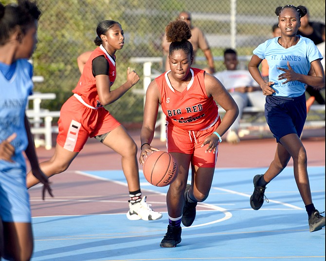 PLAY ACTION: The St Augustine’s College Big Red Machine senior girls routed the visiting St Anne’s Blue Waves by 62 points to highlight BAISS action yesterday.
Photo: Shawn Hanna/Tribune Staff