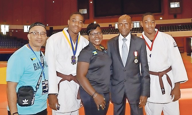 Twin brothers Alexander and Daniel Strachan with parents Mr and Mrs Anzlo Strachan and professor Hoskins Caddle, president of the Barbados Judo Association.