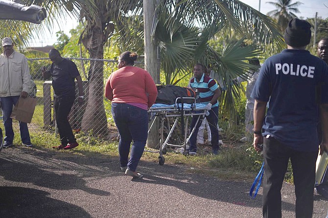 The body is removed from the scene in the Nassau Village area. Photo: Terrel W Carey Sr/Tribune staff