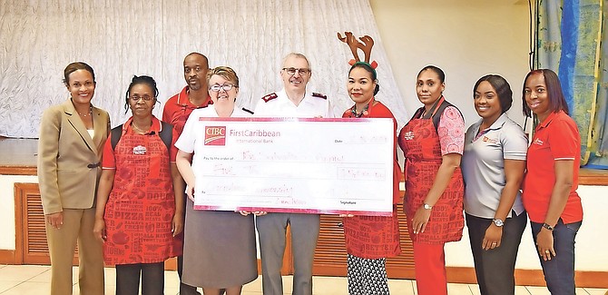 THE SALVATION Army hosted its annual Christmas lunch yesterday at St. Joseph’s Hall. CIBC First Caribbean presented a cheque of $5,000 to the Salvation Army during the event.
Photos: Shawn Hanna/Tribune Staff
