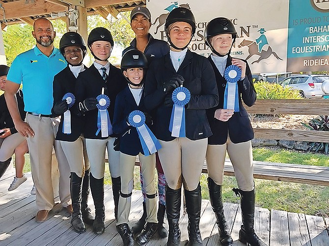 Dorian Roach, vice president of the Bahamas Olympic Committee, and Windsor School equestrian coach Erika Adderley with the victorious Windsor School team. Shown (l-r) are Alexis Neymour, Anton Gottberg, Katarina Coello, Isabella Coello and Elle O’Brien.
