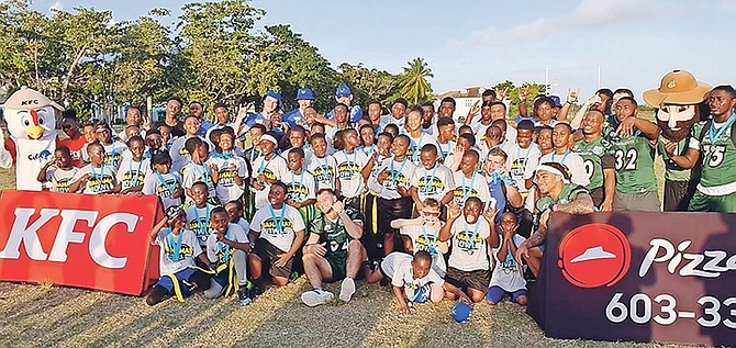 Student athletes from both the Charlotte 49ers and Buffalo Bulls participated in a community-building exercise with aspiring football players yesterday when they hosted a Youth Football Leadership Clinic, in conjunction with USA Football, at the fields opposite the original Thomas A Robinson Stadium.