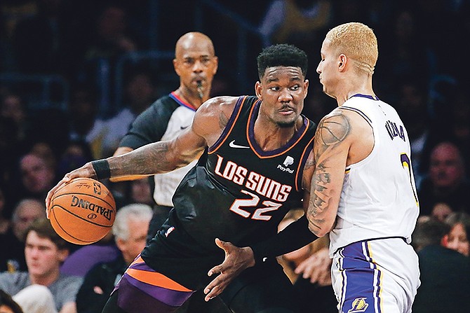 Phoenix Suns’ Deandre Ayton (22) drives against Los Angeles Lakers’ Kyle Kuzma (0) during the second half.