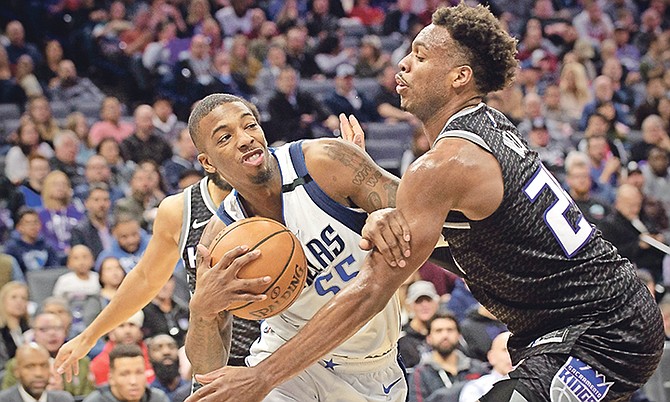 Mavericks guard Delon Wright (55) drives to the basket past Kings guard Buddy Hield (24) during the first quarter on Wednesday night.

(AP Photo/Randall Benton)