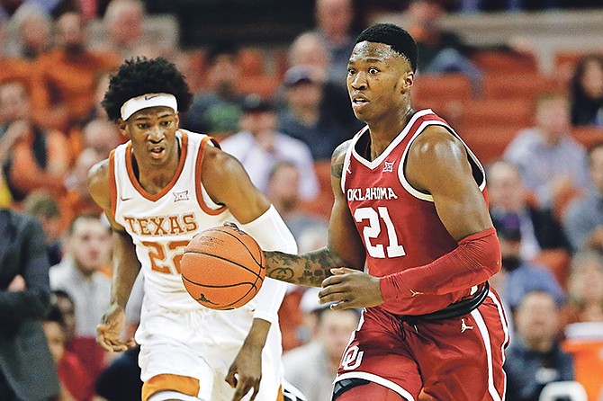 Oklahoma forward Kristian Doolittle (21) moves to the ball up court past Texas forward Kai Jones (22) during the first half on Wednesday, January 8.