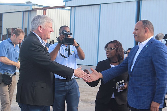 Minister of Health Dr Duane Sands (right) greets Franklin Graham, President of Samaritans Purse, in Grand Bahama on Friday.