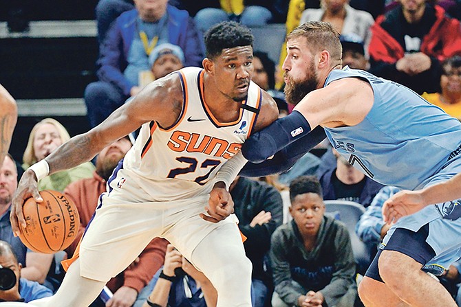 Phoenix Suns centre Deandre Ayton (22) handles the ball against Memphis Grizzlies centre Jonas Valanciunas (17) in the first half last night.