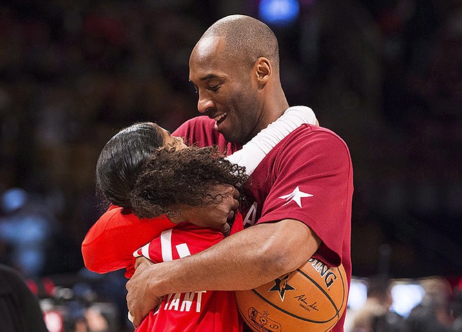 Kobe Bryant hugs his daughter Gianna in 2016. (Mark Blinch/The Canadian Press via AP)