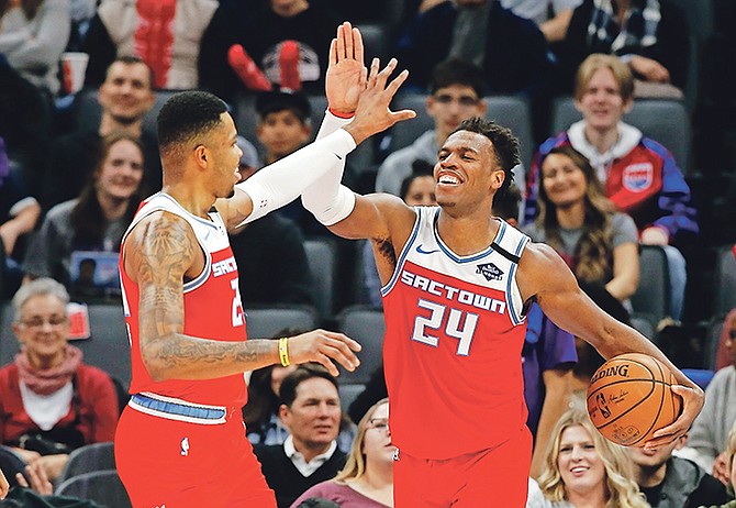 Sacramento Kings’ Kent Bazemore, left, and Buddy Hield celebrate in the closing moments of the Kings’ 122-102 win over the San Antonio Spurs in in Sacramento, California, on Saturday, February 8. Hield became the fastest player in NBA history to reach 800 career 3-pointers, doing it in 296 games.

(AP Photo/Rich Pedroncelli)