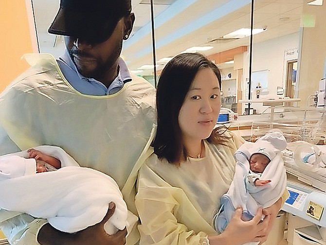 Parents Michael Russell and Cecilia Sit with their twin babies Michael Jr and Jed, after Jed survived an operation to remove a growth one and a half times the size of his own head.