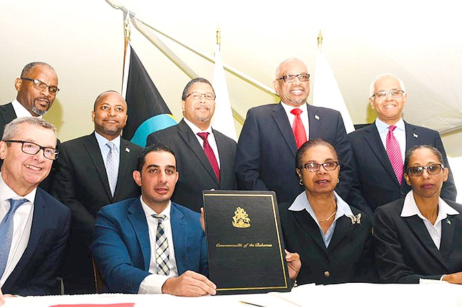 The government and Bahamas Port Investments Ltd signed a Heads of Agreement for the purchase of the Grand Lucayan on Monday.

Seated at left are Royal Caribbean International President and CEO Michel Bayley and CEO of ITM Mauricio Hamui, representing the Developer; Secretary to the Cabinet Camille Johnson (second right) and Director of Investments Candia Ferguson. Standing from left: Minister Iram Lewis, Minister of State Kwasi Thompson, Deputy Prime Minister Peter Turnquest, Prime Minister Hubert Minnis, and Minister Dionisio D'Aguilar.   (BIS Photo/Yontalay Bowe)