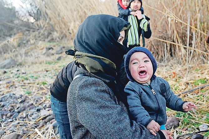 A baby cries as migrants arrive at the village of Skala Sikaminias, on the Greek island of Lesbos, after crossing on a dinghy the Aegean sea from Turkey on Monday, March 2.

Photo: Michael Varaklas/AP