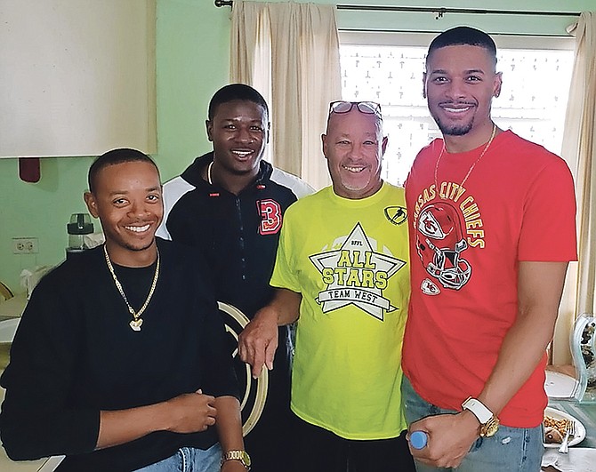 NFL Super Bowl champion Rashad Fenton (second left) poses with Cory, Chester and Jory Fox during a visit to Nassau on a cruise ship.