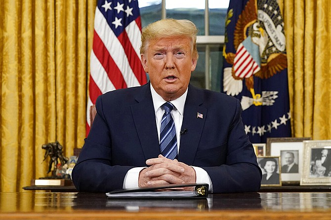 President Donald Trump speaks in an address to the nation from the Oval Office at the White House about the coronavirus Wednesday, in Washington. (Doug Mills/The New York Times via AP, Pool)