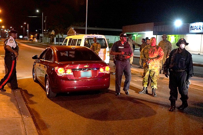 Police on the streets of New Providence during the curfew on Friday night.