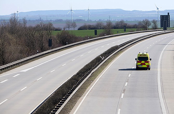 An emergency and rescue car drives on the deserted A4 highway near Erfurt, Germany, Monday.