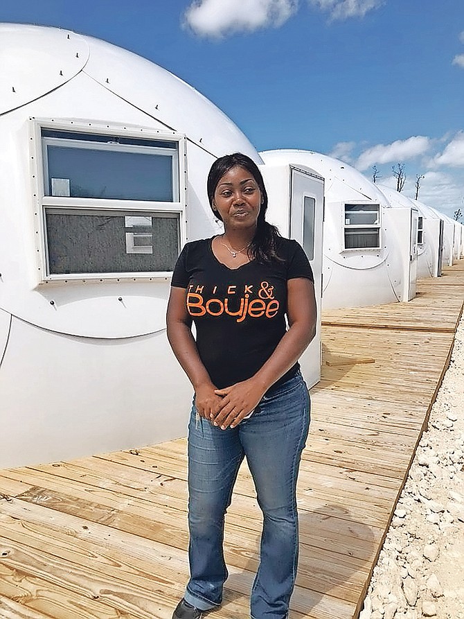 Before entering her new temporary housing dome, Abaco resident Natalie Hepburn McCardy stands in front of a row of new domes erected for 32 families in Spring City, Abaco. (Disaster Reconstruction Authority)