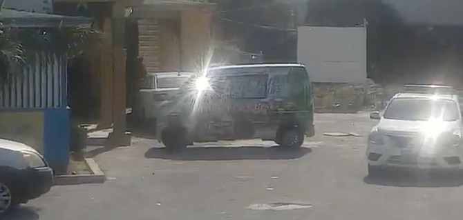 A police car outside a liquor store in an image taken from a video circulating on social media
