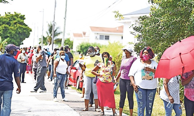 Scores of hotel union members stood in long lines outside the union headquarters on Monday to receive food vouchers. Photo: Shawn Hanna/Tribune Staff