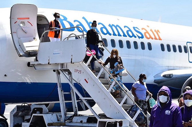 Returning nationals and residents arrive in The Bahamas on Friday.