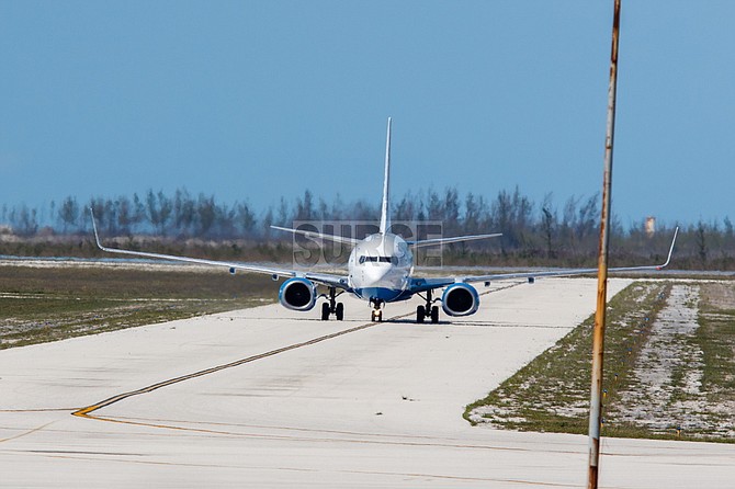 A Bahamasair flight carrying Bahamian nationals and residents makes its way along a taxiway towards the airport terminal Friday in Freeport, Grand Bahama. The flight was part of a repatriation exercise the Government implemented to bring nationals and residents home from Florida. (SURGE Media Photo/Tim Aylen)