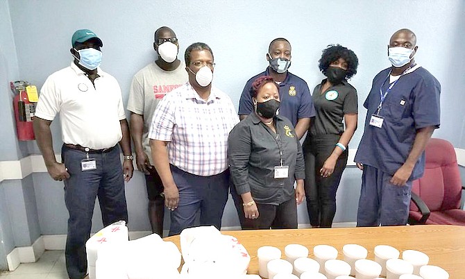 Alexander Burrows Jr, (third from left back row) and members of the Power Team, provide lunch to EMS Department in Freeport.