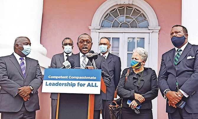 Members of the PLP held a press conference outside the House of Assembly after the Budget presentation. PLP Deputy Leader Chester Cooper is pictured giving remarks. Photo: Shawn Hanna/Tribune staff