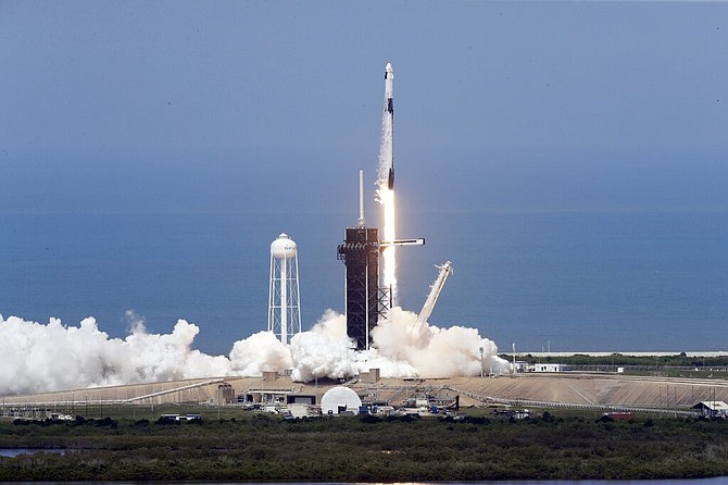 The SpaceX Falcon 9, with NASA astronauts Doug Hurley and Bob Behnken in the Dragon crew capsule, prepares to lift off from Pad 39-A at the Kennedy Space Center in Cape Canaveral, Fla., Saturday. (AP Photo/Chris O'Meara)