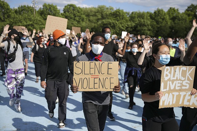 Protesters march in the Queens borough of New York, Sunday. Demonstrators took to the streets of New York City to protest the death of George Floyd, a black man who was killed in police custody in Minneapolis on May 25. (AP Photo/Seth Wenig)