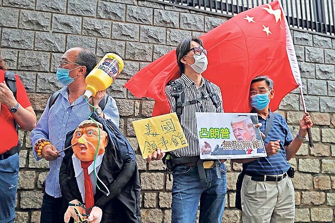 Pro-China supporters hold the effigy of U.S. President Donald Trump and Chinese national flag outside the US Consulate during a protest, in Hong Kong at the weekend. (AP)