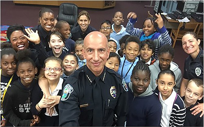 Hollywood officers serve as mentors to at-risk students and the department has established its Cops Mentoring Kids programme. Above, former police chief Sanchez.