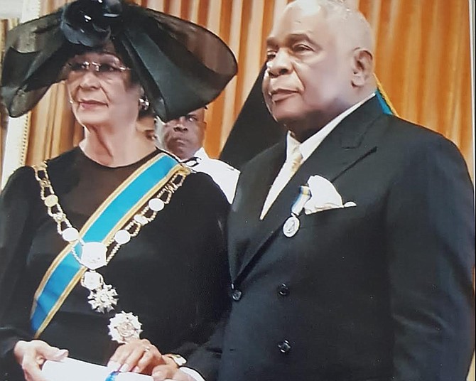 DR Patrick Roberts receiving his National Honour of Distinction from the-then Governor General, Dame Marguerite Pindling. Current GG CA Smith called him a true Bahamian patriot.